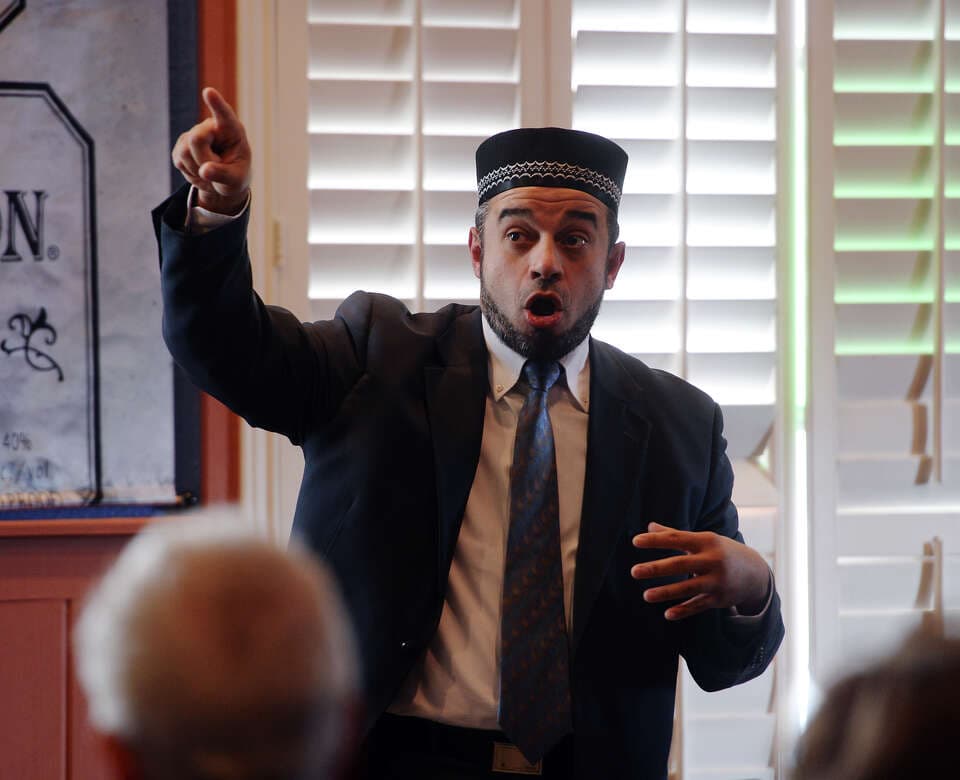 Nidal Alsayyed speaking passionately with a raised hand